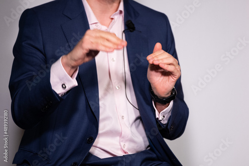 Successful businessman gestures with his hands, holds a business conference