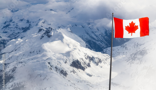 Canadian National Flag Composite with Mountain Nature Landscape during winter season with snow. Aerial Background Image from British Columbia, Canada near Squamish.