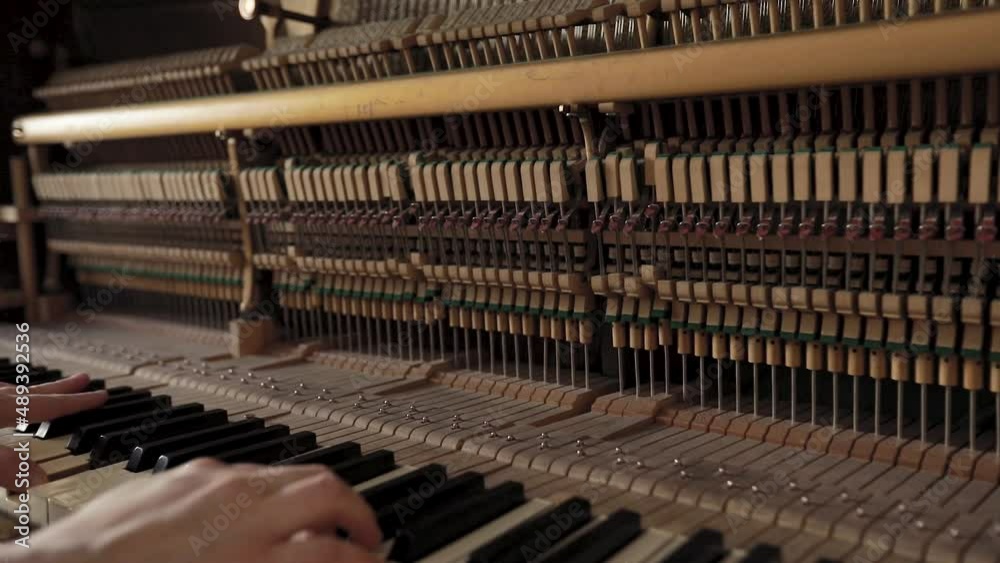 Woman play on open vintage wooden piano