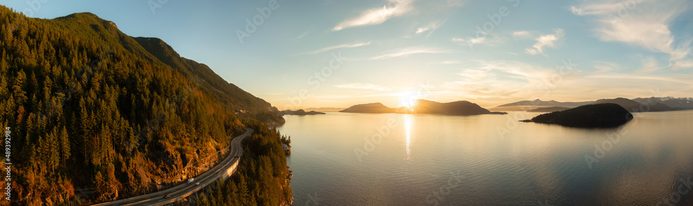 Fototapeta premium Aerial Panoramic View of Sea to Sky Highway on Pacific Ocean West Coast. Sunny Winter Colorful Sunset. Located in Howe Sound between Vancouver and Squamish, British Columbia, Canada.