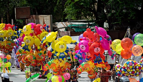 Colorful, smiling air filled balloon toys for sell in holy procession of Pandharpur Palkhi