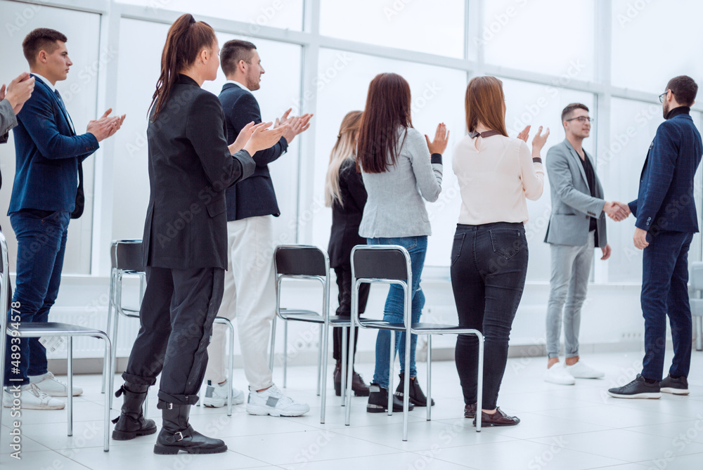 project Manager and business team congratulating the best employee. project Manager and business team congratulating the best employee.