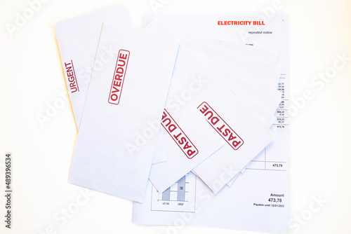 Obraz na plátne Electricity bill and stack of mail envelopes marked urgent, overdue, past due as