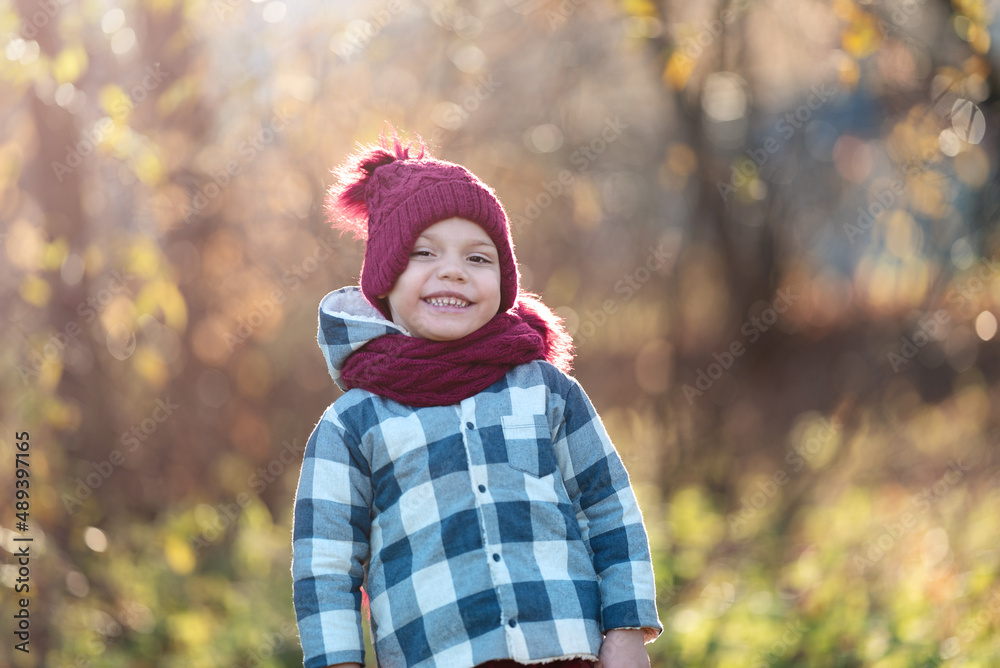 Portrait of a smiling little boy in a hat and scarf in autumn with copy space Portrait of a smiling little boy in a hat and scarf in autumn with copy space