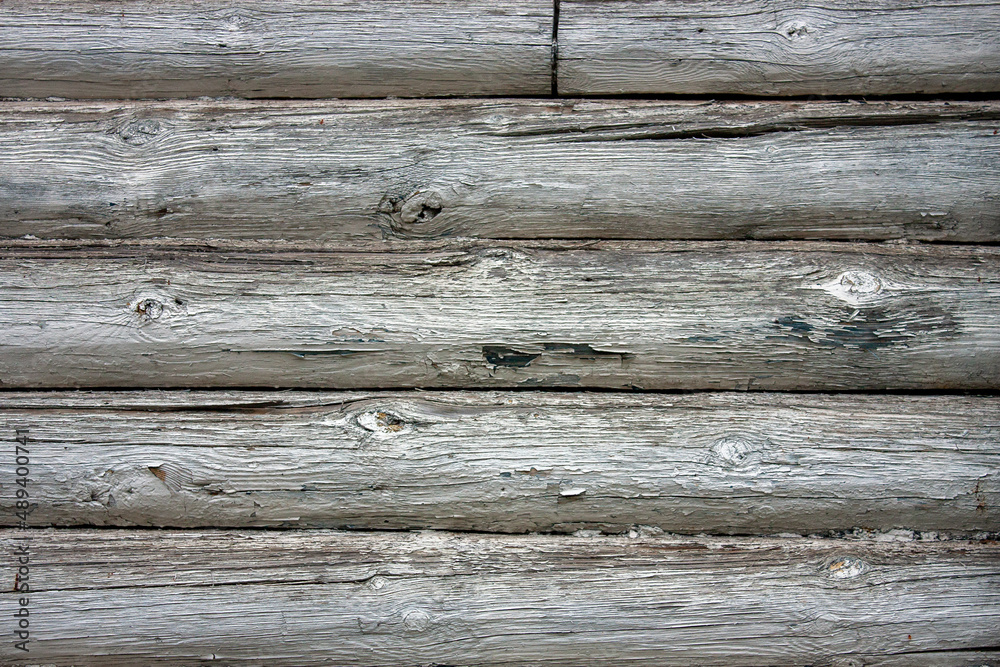 Fragment of a wall made of old logs. Close-up, flat lay. Natural tree. Texture of natural wood close up. Natural wood cladding Fragment of a wall made of old logs. Close-up, flat lay. Natural tree. Texture of natural wood close up. Natural wood cladding