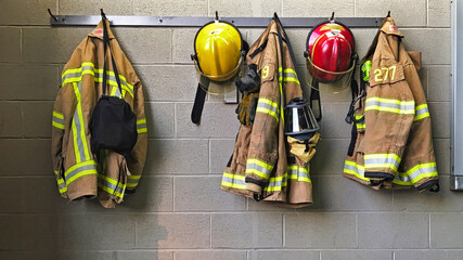 Firefighter helmet and protection coat hanging in the fire station