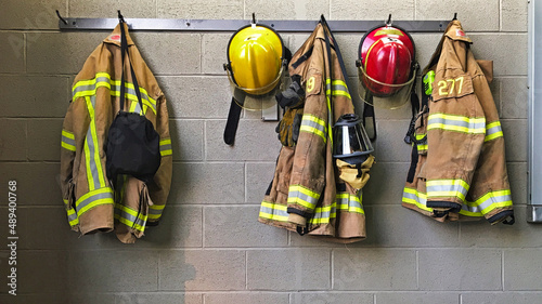 Firefighter helmet and protection coat hanging in the fire station photo