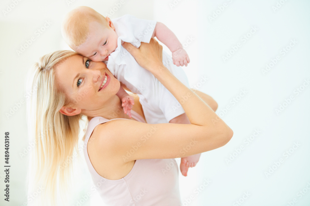Loving mother and her bundle of joy. A lovely mother lifting her adorable baby girl. Loving mother and her bundle of joy. A lovely mother lifting her adorable baby girl.
