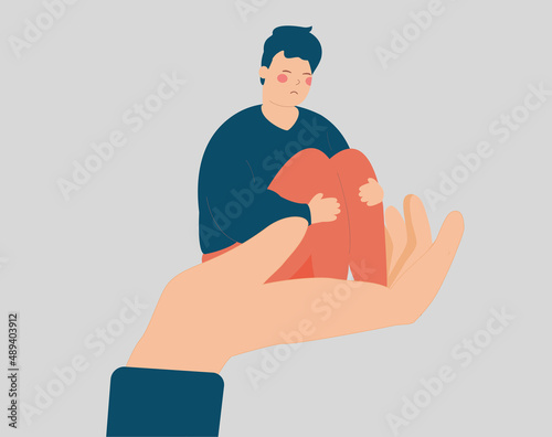 Stressed man sits on a big hand. Male needs care and support because of depression and stress. Counselor helps a sad teenager boy to get rid of psychological problems. Mental health disorders concept.