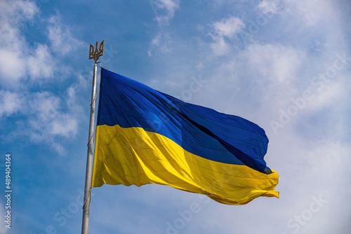 Ukrainian national official flag on blue sky background photo