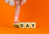 Today is my day symbol. Businessman turns the wooden cube and changes concept words Today to My day. Beautiful orange table orange background, copy space. Business, motivation today is my day concept.