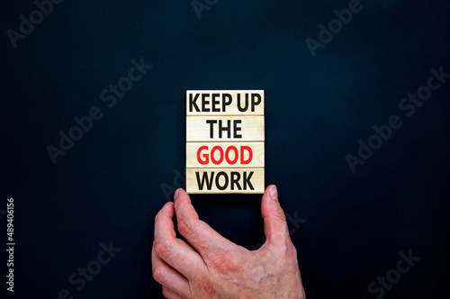 Keep up the good work symbol. Concept words Keep up the good work on wooden blocks. Businessman hand. Beautiful black table black background. Keep up the good work business concept. Copy space.