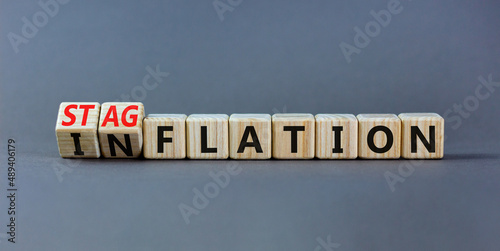 Stagflation or inflation symbol. Turned wooden cubes and changed the concept word inflation to stagflation. Beautiful grey table grey background, copy space. Business stagflation or inflation concept. photo