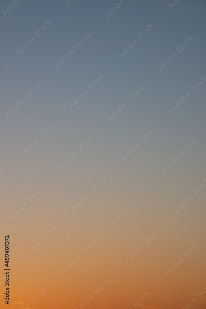 Cover page with clear gradient sky with no clouds at sunset colors as a background with copy space.