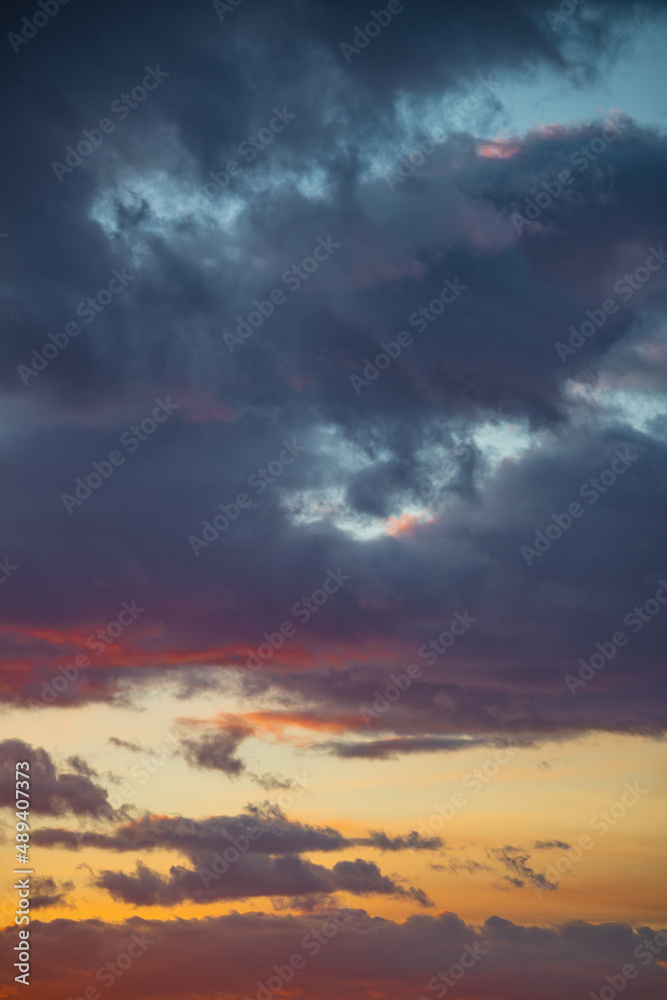 Cover page with dramatic rainy sky with heavy clouds at sunset as a background with copy space.