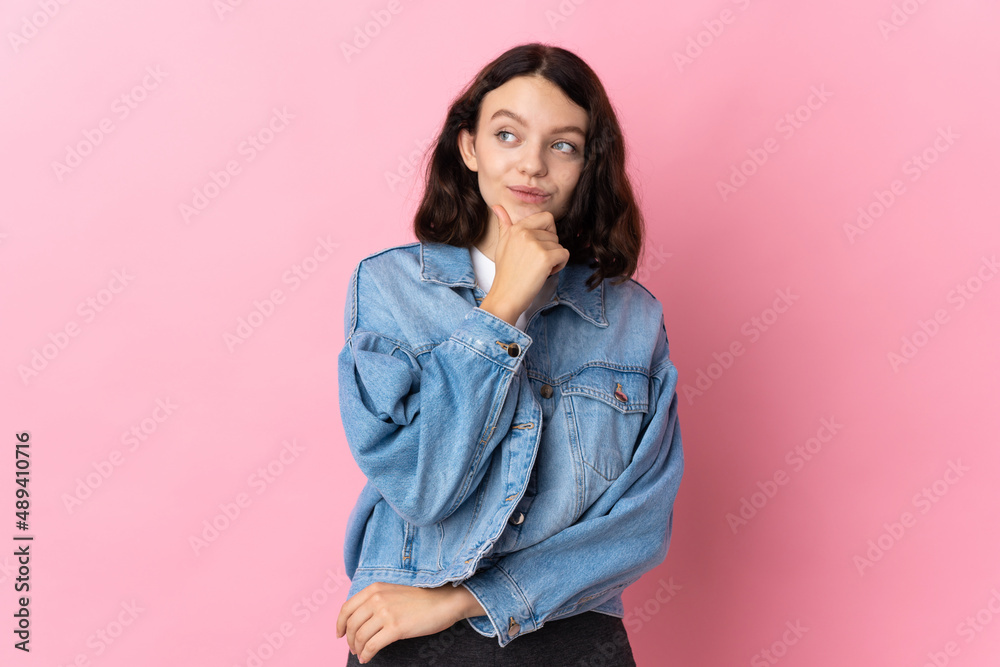 Teenager Ukrainian girl isolated on pink background thinking an idea while looking up Teenager Ukrainian girl isolated on pink background thinking an idea while looking up