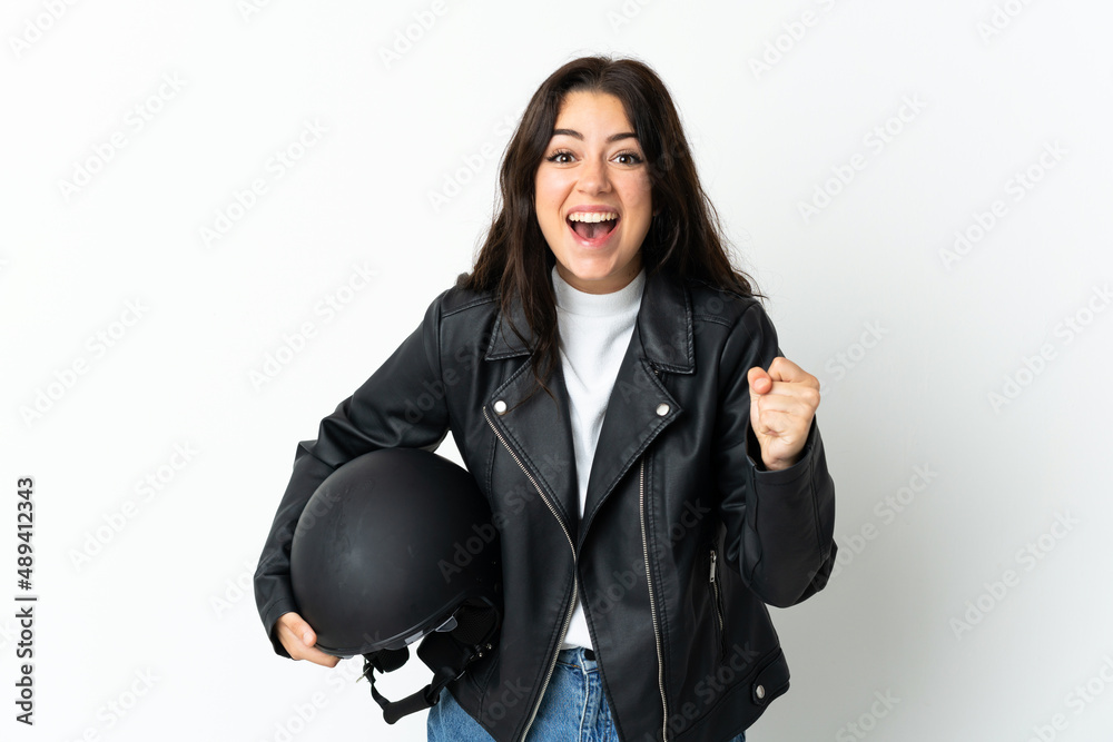 Woman holding a motorcycle helmet isolated on white background celebrating a victory in winner position Woman holding a motorcycle helmet isolated on white background celebrating a victory in winner position