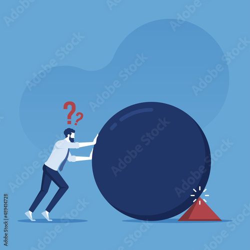 Business problem concept, businessman pushes a big ball and is blocked by a small triangle, businessmen are confused because they do not know the problem that occurs