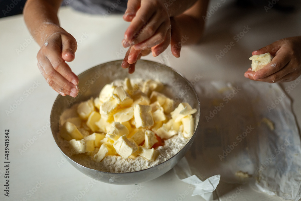kids hands on a bowl with butter