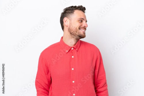 Young Brazilian man isolated on white background looking side © luismolinero