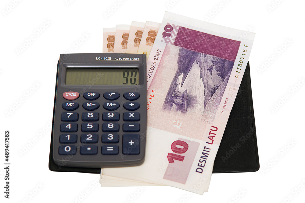 A small electronic calculator and several banknotes A small electronic calculator and several banknotes