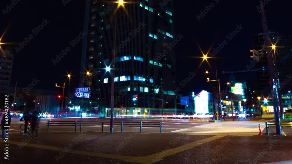 A night timelapse of the traffic jam at the city crossing in Tokyo wide shot panning A night timelapse of the traffic jam at the city crossing in Tokyo wide shot panning