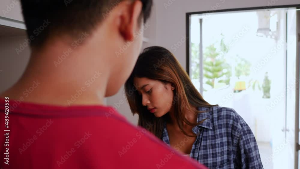 Slow motion shot, Close up, Asian young couple help to holding heavy cardboard box walk into new house with happiness, new house concept Slow motion shot, Close up, Asian young couple help to holding heavy cardboard box walk into new house with happiness, new house concept