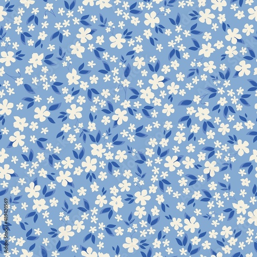 Seamless vintage pattern. Small white flowers and blue leaves. Light blue background. vector texture. fashionable print for textiles, wallpaper and packaging.