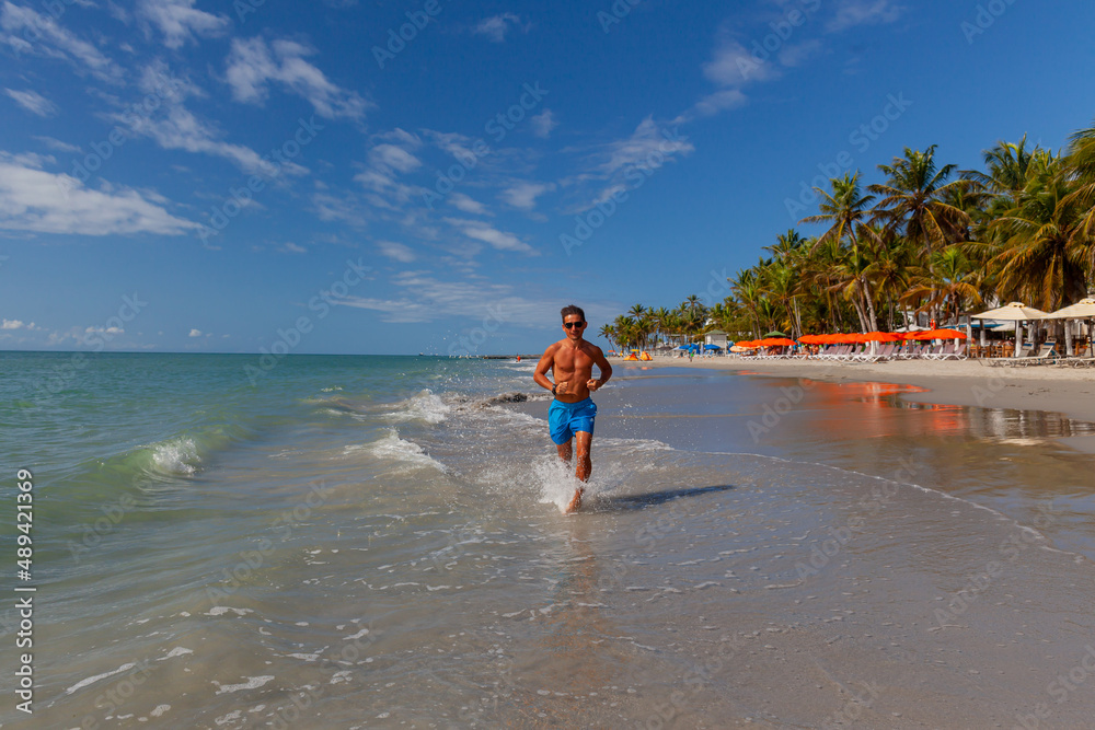 running athletic, athletic man, on the coast of venezuela, caribbean islands