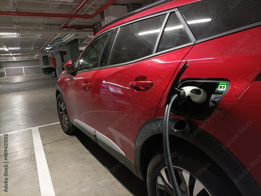 EV Car or Electric vehicle at charging station cable supply with blue enegy power effect EV Car or Electric vehicle at charging station cable supply with blue enegy power effect