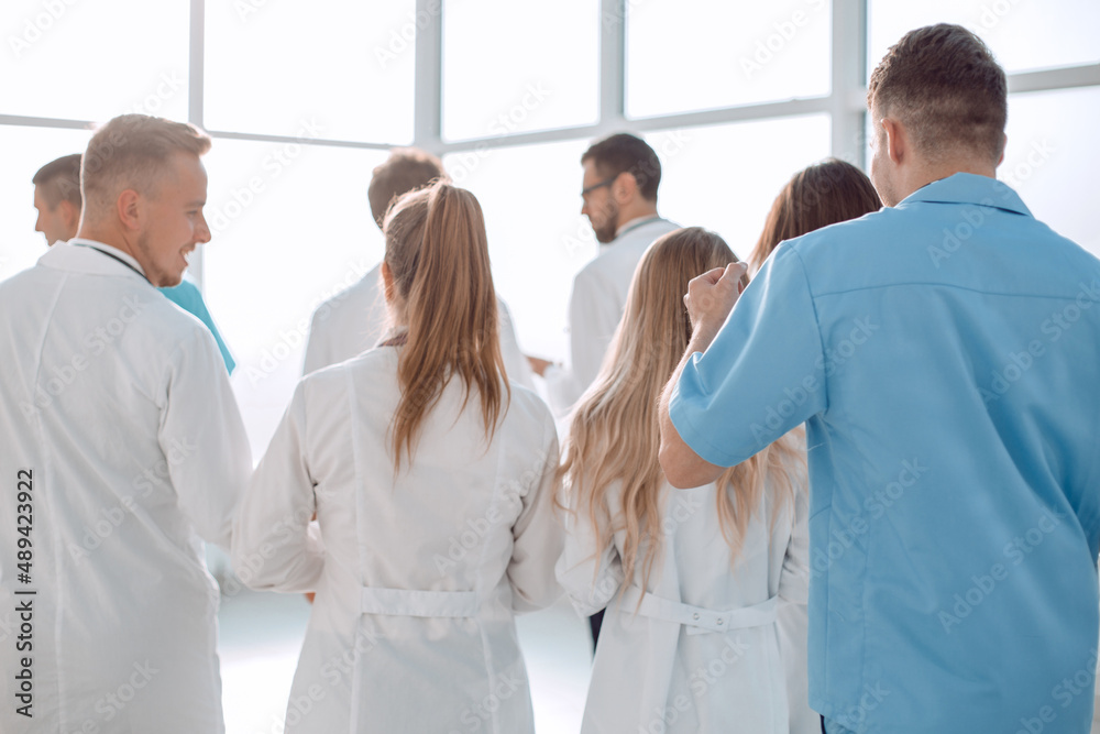 group of doctors discussing something standing in the hospital lobby group of doctors discussing something standing in the hospital lobby