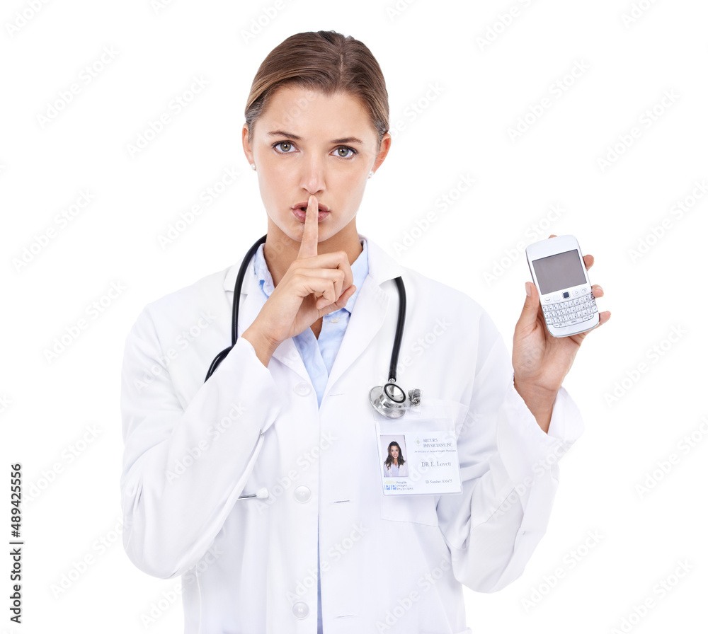 Doctor-client privelage. Portrait of an attractive young doctor telling you to be quiet while holding a cellphone. Doctor-client privelage. Portrait of an attractive young doctor telling you to be quiet while holding a cellphone.