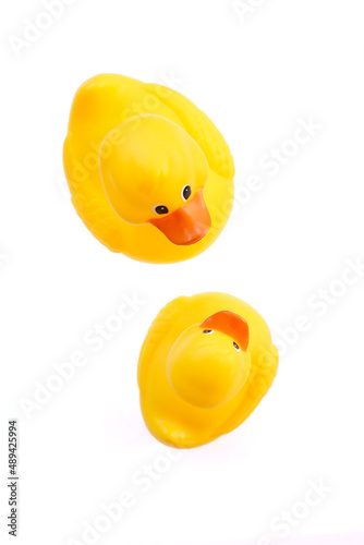 Yellow rubber duck bath toys on white background viewed above