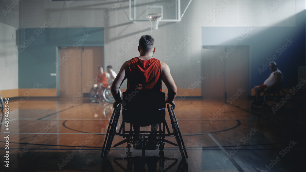 Wheelchair Basketball Game: Professional Player Prepairing to Play. He is Ready to Compete, Dribble Ball, Pass, Shoot it, Score a Goal. Concept with Gray Colors, Depressive Mood.