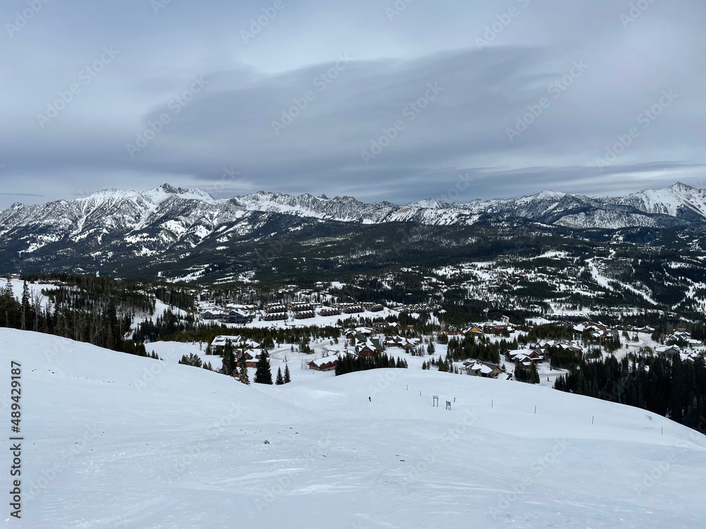 Moody view of the mountains and slopes of Big Sky Ski Resort on a cloudy winter day