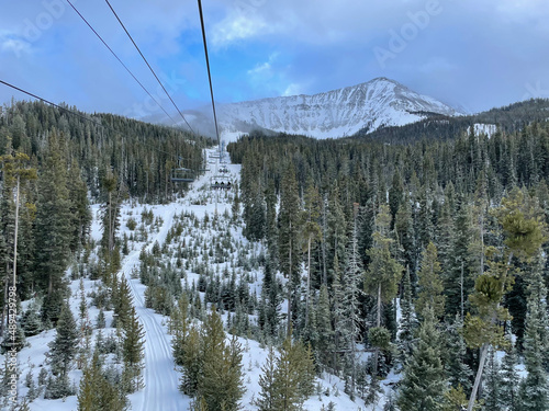 Scenic view of chairlift and snow covered slopes at Big Sky Ski Resort in Montana on a sunny winter day