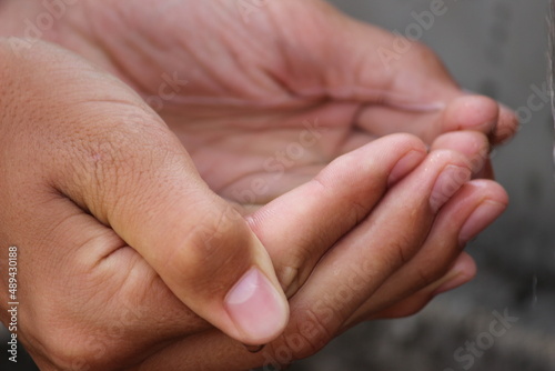 hands of parent and child holding water