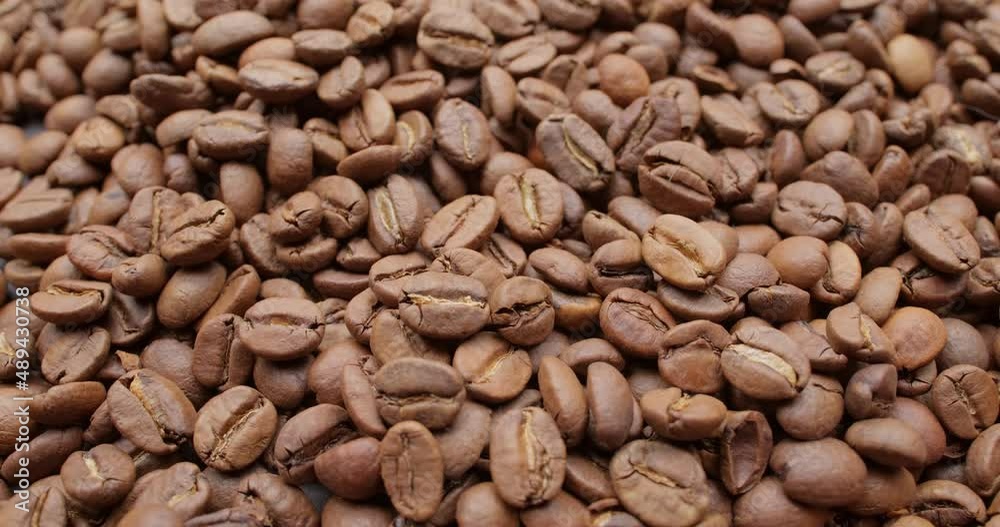 Close up of seeds of coffee. Fragrant coffee beans are roasted smoke comes from coffee beans. Close up of seeds of coffee. Fragrant coffee beans are roasted smoke comes from coffee beans.