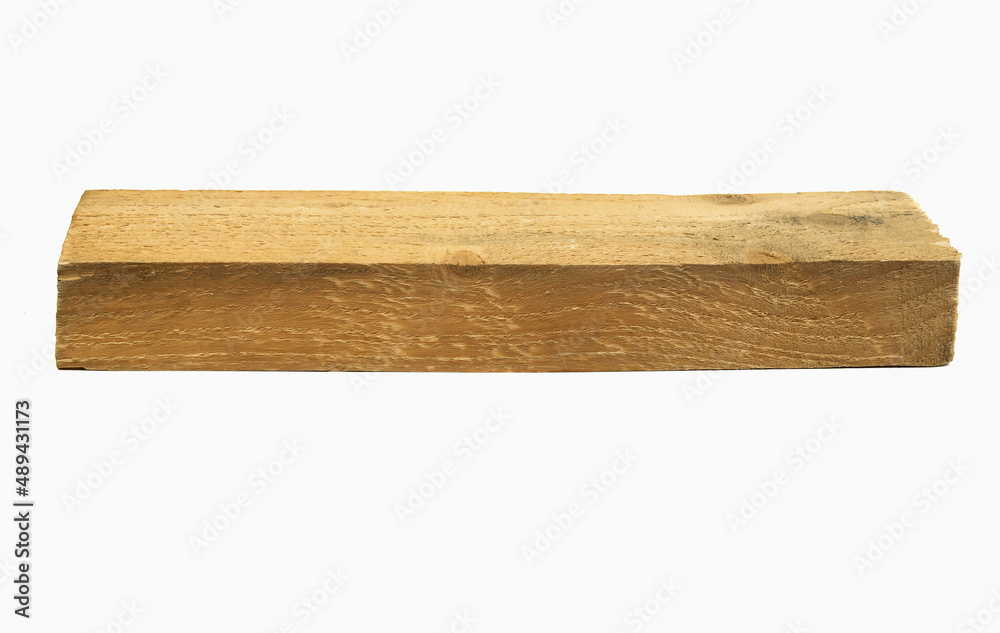 A long and narrow wooden beam isolated on a white background.Roughly processed wooden beam.Cracks and resin drips on the wooden block.