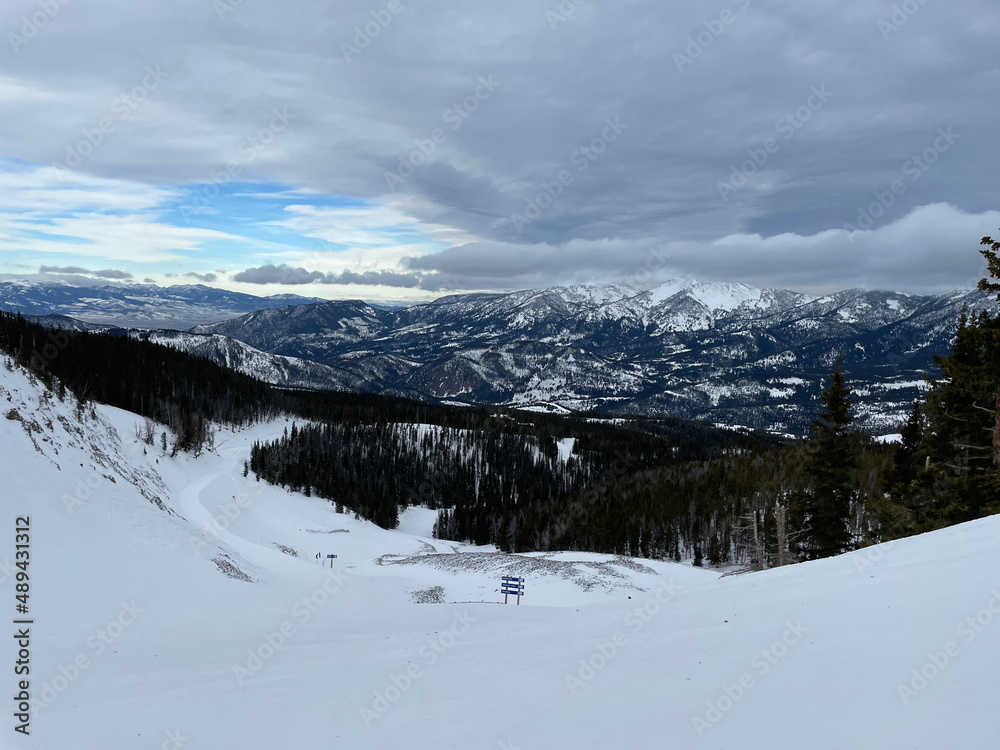 Scenic view of snow covered slopes at a ski resort in Montana on a cloudy winter day