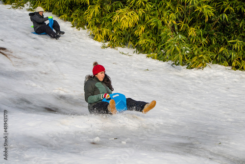 Brincando na neve, escorregando usando um esqui,
uma prancha para ecorregar photo