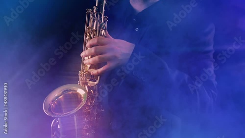 Energetic Saxophone Player In Party Lights And Smoke photo