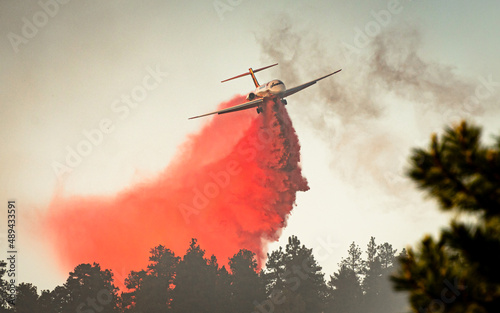A large air tanker drops red fire retardant on an Oregon wildfire photo