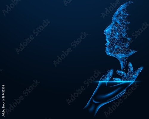 Artificial intelligence. The silhouette of the face above the palm of the hand. Polygonal design of lines and dots. Blue background.