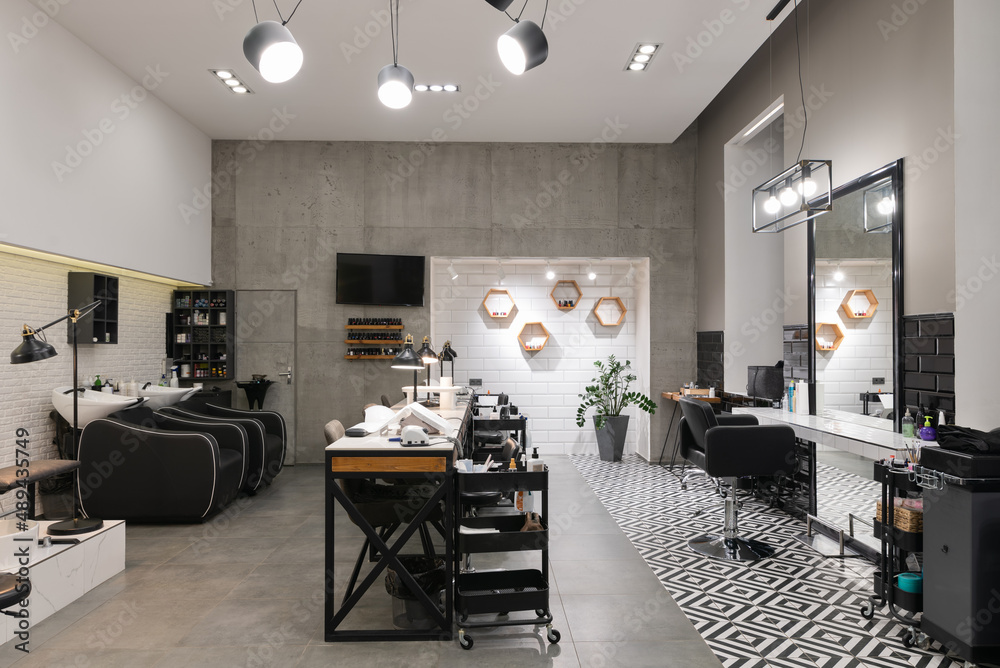 Modern interior of the beauty salon which consist of nail salon and barbershop.