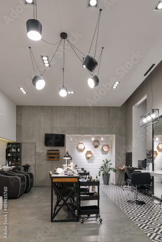 Modern interior of the beauty salon which consist of nail salon and barbershop.