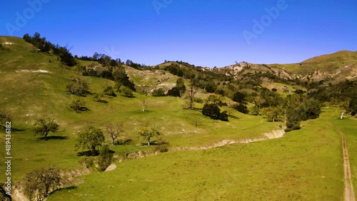 A collection of drone shots revealing incredible natural California landscapes, featuring vast lush views of green rolling hills, oak trees, and beautiful ranch land. photo