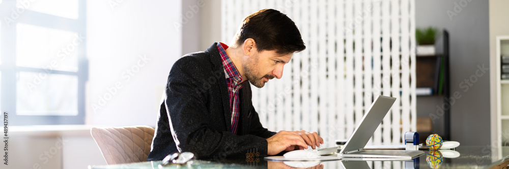 Man Sitting In Bad Posture Working On Computer Man Sitting In Bad Posture Working On Computer