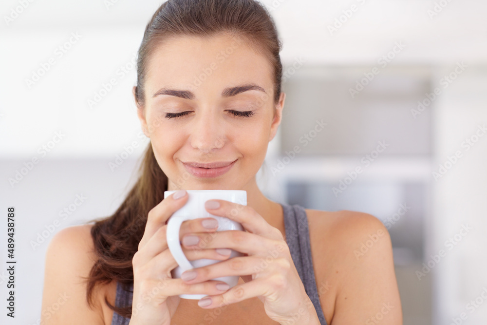 The aroma of morning coffee. An attractive young woman taking in the aroma of her coffee. The aroma of morning coffee. An attractive young woman taking in the aroma of her coffee.