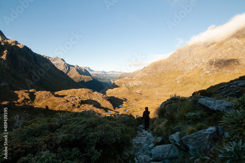 Hiker at Routeburn Track Great Walk walking down to Routeburn Valley, Tramping in New Zealand